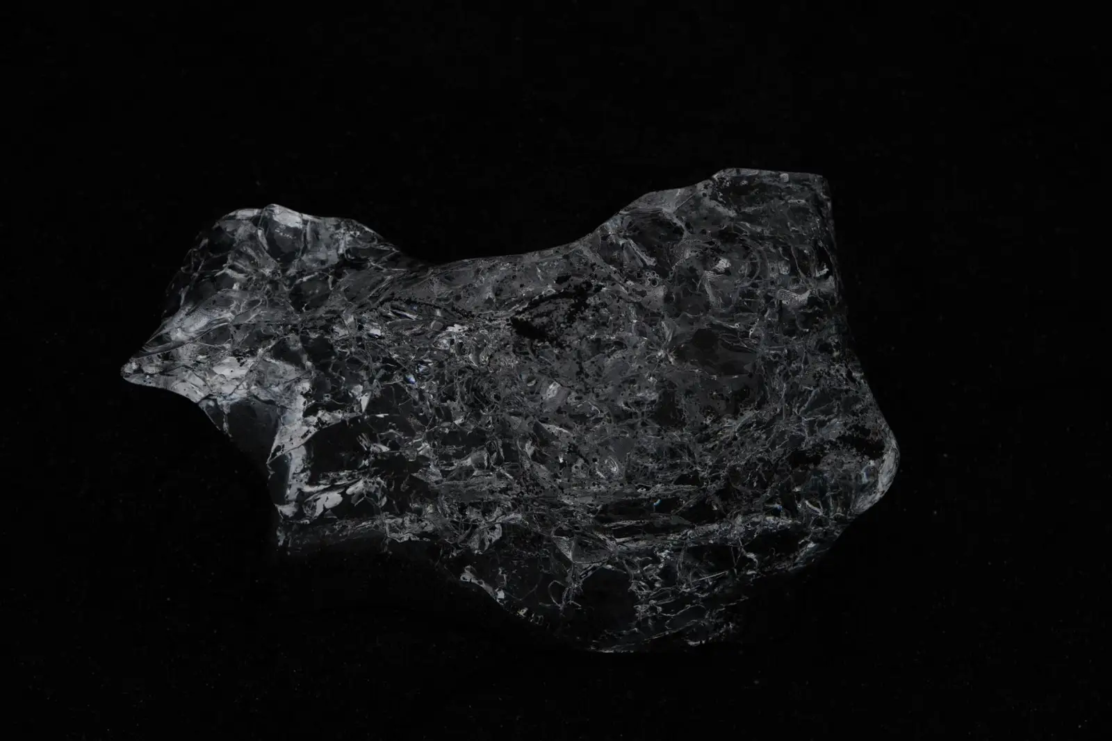 A rough, unpolished crystal photographed on black