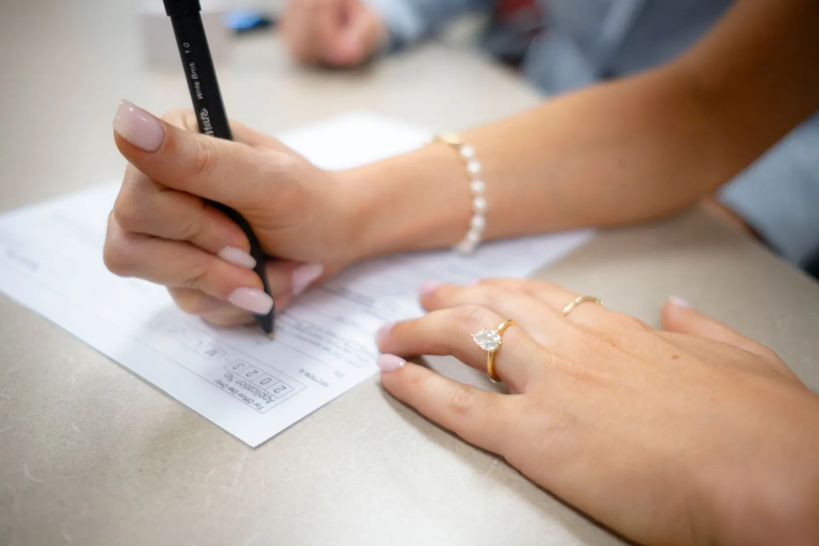 A diamond grading report and a loose round brilliant, the two things a report check compares