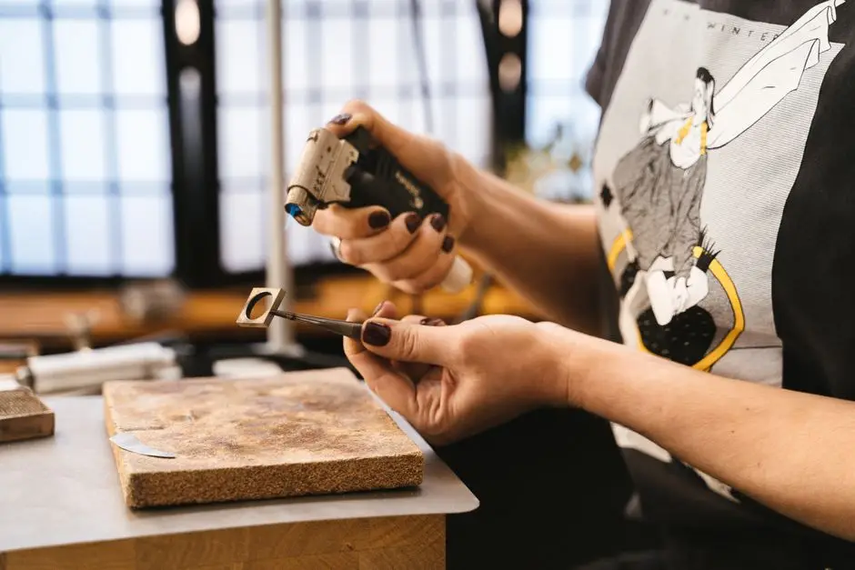 Goldsmith setting a stone into a ring at the bench