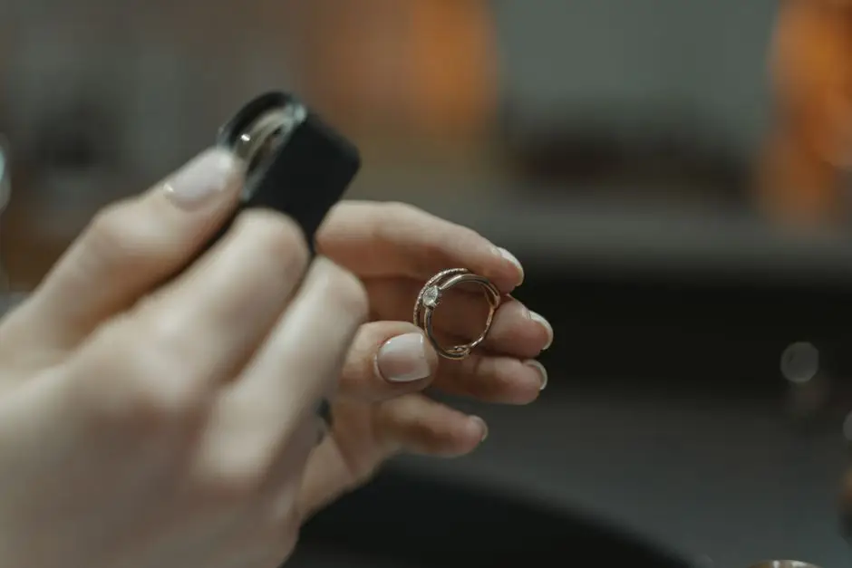 Diamond ring held up to a jeweller's loupe, the stone checked against its report