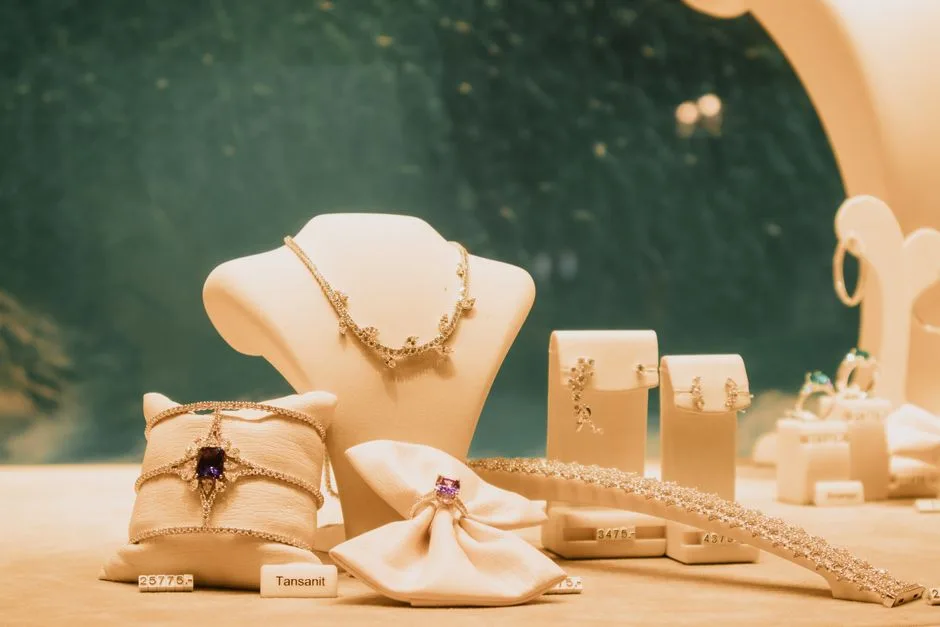 Diamond and gold earrings arranged on a jewellery display