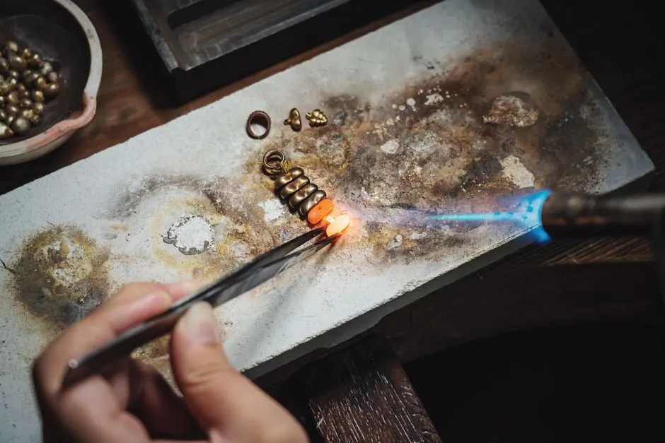 Goldsmith shaping a ring at the workshop bench